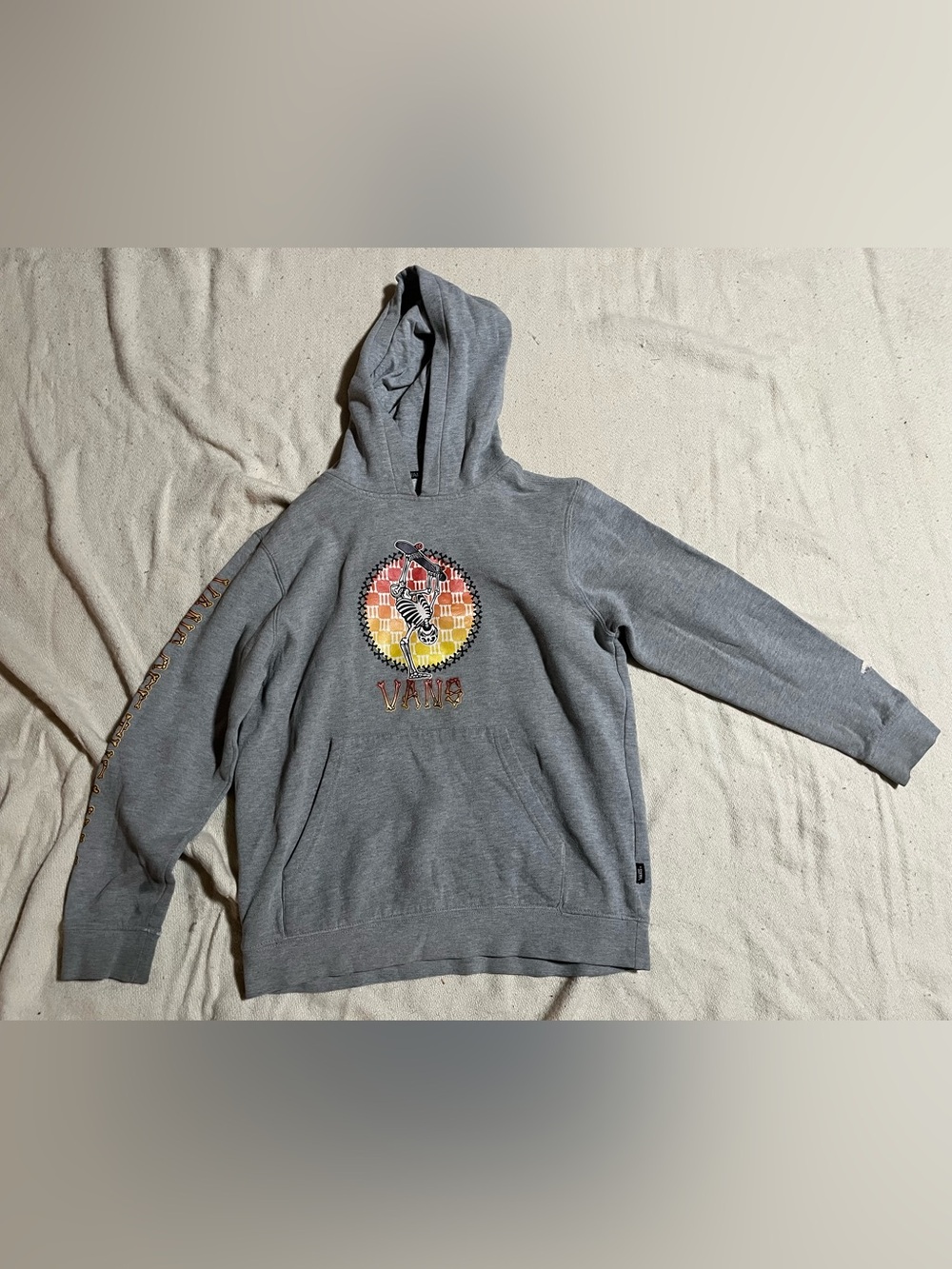 Kids Vans Gray Hoodie with Skeleton Graphic.